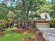 Charming brick home with a two-car garage, dormer windows, mature trees and well-maintained landscaping at 2010 Pearwood Path, Roswell, GA 30076