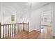 Hallway with hardwood floors, white trim, and natural lighting from the window at 2010 Pearwood Path, Roswell, GA 30076