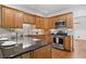 Well-equipped kitchen with stainless steel appliances, wooden cabinets, and black countertops at 2010 Pearwood Path, Roswell, GA 30076