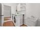 Modern laundry room featuring sink, folding counter, washer, dryer, and shelving at 2010 Pearwood Path, Roswell, GA 30076