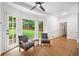 Bright seating area with hardwood floors, ceiling fan, and a window view to the green yard at 2010 Pearwood Path, Roswell, GA 30076
