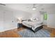 Bright main bedroom featuring ceiling fan, hardwood floors, and modern decor at 2010 Pearwood Path, Roswell, GA 30076
