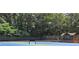 Community tennis courts featuring two blue courts surrounded by trees and a gazebo at 2010 Pearwood Path, Roswell, GA 30076