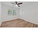 This bedroom has wood flooring, a ceiling fan, a window, and closet at 2060 Panstone Sw Ct, Marietta, GA 30060