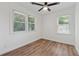 Bedroom features wood flooring, a ceiling fan, and two windows at 2060 Panstone Sw Ct, Marietta, GA 30060