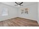 This bedroom has wood flooring, a ceiling fan, and two windows at 2060 Panstone Sw Ct, Marietta, GA 30060