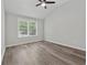 Bedroom features vaulted ceiling, wood flooring, and natural light from a large window at 2060 Panstone Sw Ct, Marietta, GA 30060