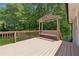 Outdoor deck with bench and pergola offers a tranquil space surrounded by lush greenery at 2060 Panstone Sw Ct, Marietta, GA 30060