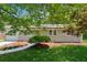 Quaint one-story home with a vibrant green lawn and mature landscaping at 2060 Panstone Sw Ct, Marietta, GA 30060