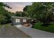 Charming one-story home with a well-manicured lawn and newly paved driveway at dusk at 2060 Panstone Sw Ct, Marietta, GA 30060