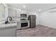 Modern kitchen with gray cabinets, stainless steel appliances, and granite countertops at 2060 Panstone Sw Ct, Marietta, GA 30060