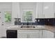 Bright kitchen features granite counters, stainless sink, subway tile backsplash and modern cabinets at 2060 Panstone Sw Ct, Marietta, GA 30060