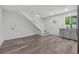 Inviting living area with modern finishes, an adjacent kitchen, and staircase access at 2060 Panstone Sw Ct, Marietta, GA 30060