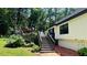Backyard features a wooden deck with stairs and a beautifully landscaped yard with mature trees at 2985 Heather Stone Way, Lawrenceville, GA 30043