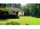 Expansive backyard with lush green lawn and mature trees, perfect for outdoor activities and relaxation at 2985 Heather Stone Way, Lawrenceville, GA 30043