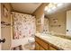 Bathroom features vanity, sink and shower with decorative curtain at 2985 Heather Stone Way, Lawrenceville, GA 30043