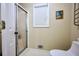 Bathroom with a tiled shower, toilet, and window with white blinds at 2985 Heather Stone Way, Lawrenceville, GA 30043