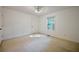 A bright bedroom with carpet, a window and a closet with ceiling fan at 2985 Heather Stone Way, Lawrenceville, GA 30043