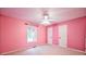 Bright pink bedroom features a ceiling fan and natural light at 2985 Heather Stone Way, Lawrenceville, GA 30043