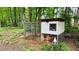 A charming chicken coop nestled in a wooded area at 2985 Heather Stone Way, Lawrenceville, GA 30043