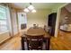 Cozy dining room with wood floors, large windows, and a classic dining table at 2985 Heather Stone Way, Lawrenceville, GA 30043