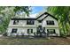 Charming two-story home featuring a symmetrical facade, black shutters, and lush landscaping at 2985 Heather Stone Way, Lawrenceville, GA 30043