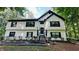 Charming two-story home featuring a symmetrical facade, black shutters, and lush landscaping at 2985 Heather Stone Way, Lawrenceville, GA 30043