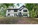 Charming two-story home with white siding, black trim, and lush green surroundings, set back on a large lot at 2985 Heather Stone Way, Lawrenceville, GA 30043