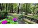 A tranquil garden path with a decorative bench, lush hydrangeas, and a serene woodland backdrop at 2985 Heather Stone Way, Lawrenceville, GA 30043