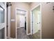 Hallway with neutral paint, white trim and white doors, and vinyl plank flooring at 2985 Heather Stone Way, Lawrenceville, GA 30043
