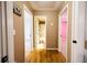 Hallway with hardwood floors and multiple doors leading to various rooms at 2985 Heather Stone Way, Lawrenceville, GA 30043