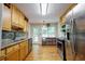 Functional kitchen with stainless steel appliances, wood cabinets, and tile backsplash at 2985 Heather Stone Way, Lawrenceville, GA 30043