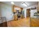 Galley kitchen featuring stainless steel appliances, wooden cabinets, and hardwood flooring at 2985 Heather Stone Way, Lawrenceville, GA 30043