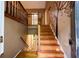 View of the home's staircase featuring wood steps, a charming tree mural, and natural light at 2985 Heather Stone Way, Lawrenceville, GA 30043