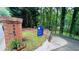 Street view of a home with a brick mailbox and a For Sale sign at the end of a tree-lined driveway at 2985 Heather Stone Way, Lawrenceville, GA 30043