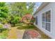 A backyard with lush landscaping and a Japanese maple tree at 3585 Berkeley Park Ct, Duluth, GA 30096