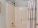 Standard white tub and shower features a gray patterned curtain and chrome fixtures at 3585 Berkeley Park Ct, Duluth, GA 30096