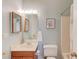 Bathroom features an oak vanity, tub/shower, and framed art for a cozy, personalized atmosphere at 3585 Berkeley Park Ct, Duluth, GA 30096