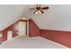 Spacious bedroom with an angled ceiling, half-painted wall, and a door leading to another room at 3585 Berkeley Park Ct, Duluth, GA 30096