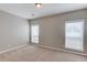 Bedroom with neutral walls, carpet, and natural light from two windows with privacy blinds at 3585 Berkeley Park Ct, Duluth, GA 30096
