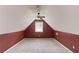 Bright bedroom with an angled ceiling, half-painted wall, and a window view at 3585 Berkeley Park Ct, Duluth, GA 30096