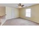 Bonus room features neutral walls, carpet, a ceiling fan, and a window with a view at 3585 Berkeley Park Ct, Duluth, GA 30096