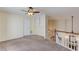 Spacious bonus room featuring a ceiling fan, built-in shelving, and staircase access at 3585 Berkeley Park Ct, Duluth, GA 30096