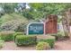 The welcoming Berkeley Park community sign sits among manicured landscaping and lush trees on a sunny day at 3585 Berkeley Park Ct, Duluth, GA 30096