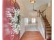 Inviting foyer with hardwood floors, a staircase, and views into the living area, highlighting the home's layout at 3585 Berkeley Park Ct, Duluth, GA 30096