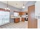 Well-lit kitchen featuring wood cabinets, white countertops, a corner sink, and tile flooring at 3585 Berkeley Park Ct, Duluth, GA 30096