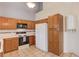 Kitchen area with ample cabinet space, white appliances, and views of the high ceiling at 3585 Berkeley Park Ct, Duluth, GA 30096