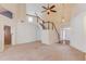 Bright living room featuring high ceilings, a staircase, and entry way into the home at 3585 Berkeley Park Ct, Duluth, GA 30096