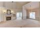Spacious living room featuring a fireplace, built-in cabinets, neutral carpeting, and ample natural light at 3585 Berkeley Park Ct, Duluth, GA 30096
