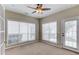 Light-filled sunroom with multiple windows, a ceiling fan, and a door to the outside, creating a peaceful retreat at 3585 Berkeley Park Ct, Duluth, GA 30096